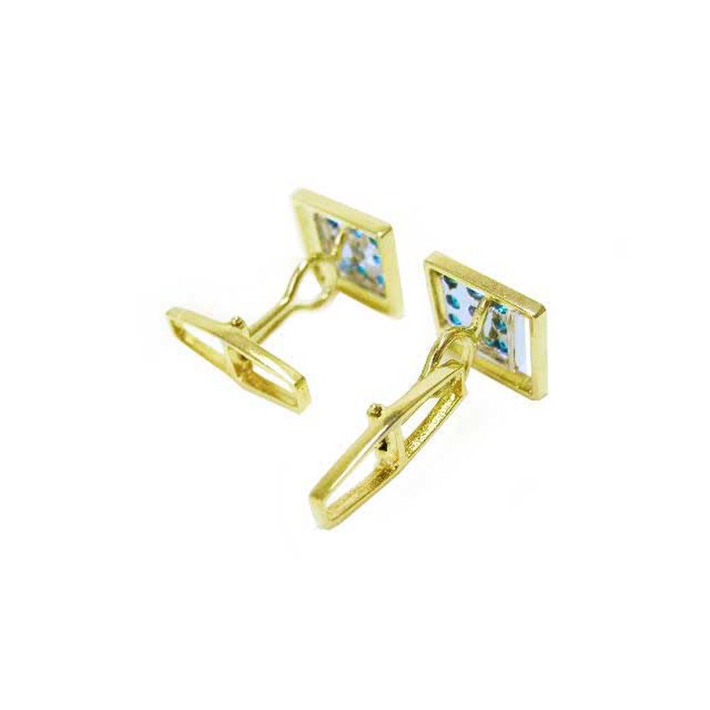 Gold square-shaped cufflinks with natural colombian emeralds on a white background.