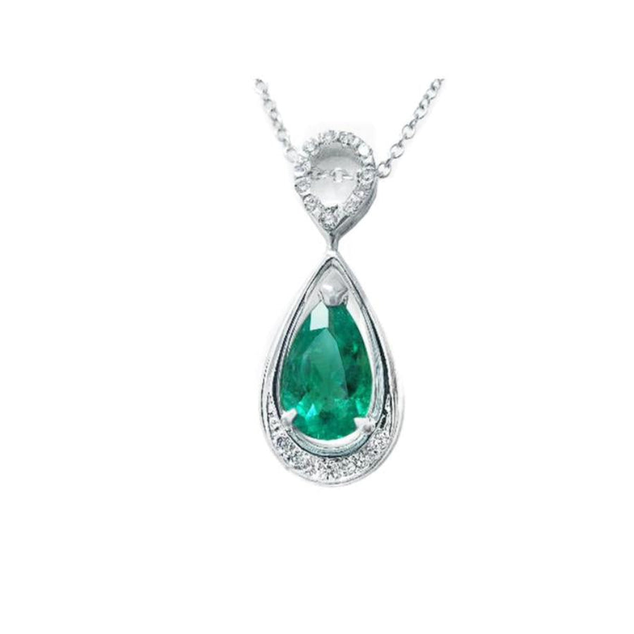 Teardrop-shaped emerald pendant with diamond accents made of 14k white gold.