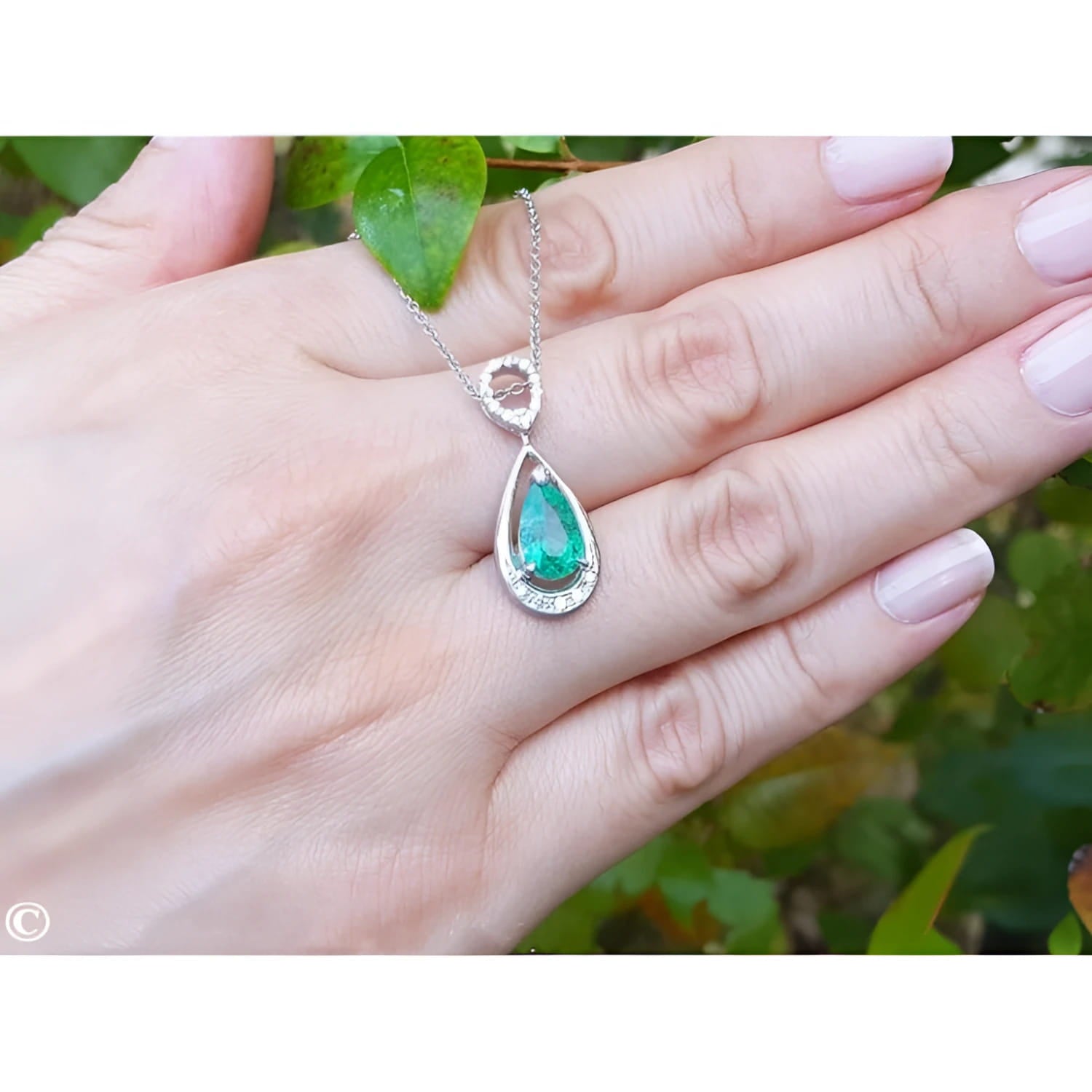 1.35 ct. natural pear-shaped emerald pendant necklace in 14K white gold with diamond bail.