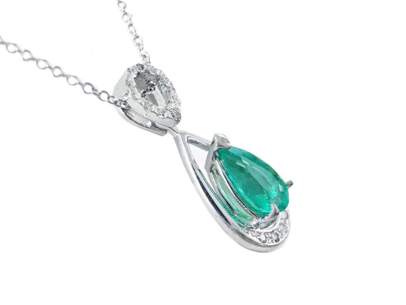 White gold pendant with a natural colombian emerald on a white background.