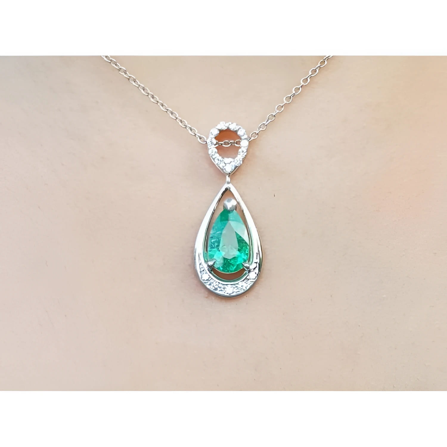 1.35 ct. natural emerald pear-shaped pendant necklace in 14K white gold with diamond bail.