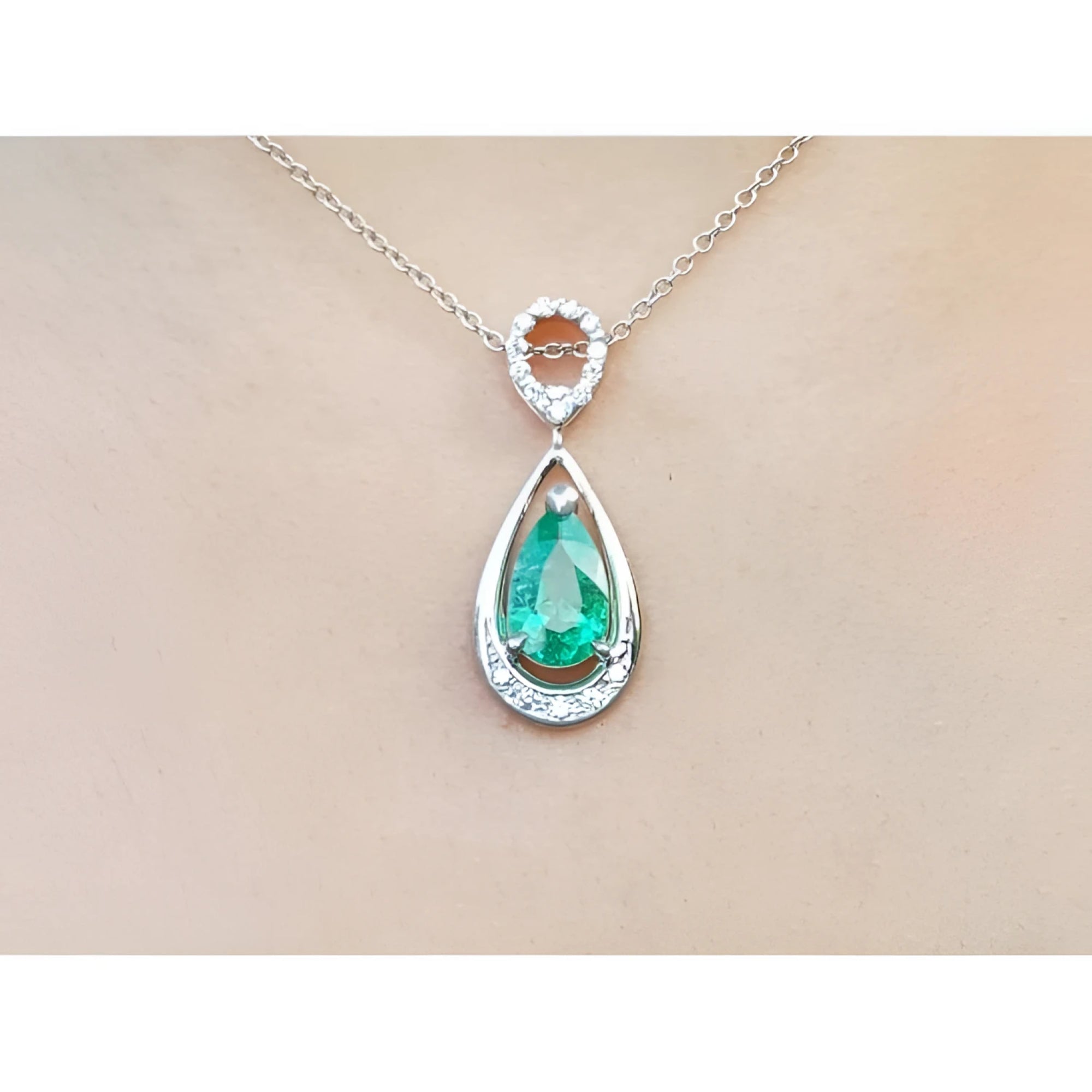 1.35 ct. natural emerald pear-shaped pendant necklace in 14K white gold with diamond bail.