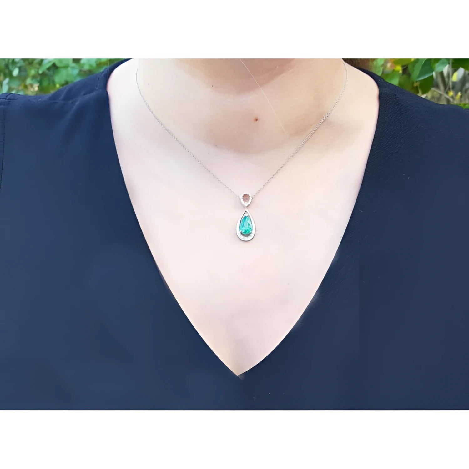 1.35 ct natural pear-shaped emerald pendant necklace with diamond bail on 14K white gold chain.