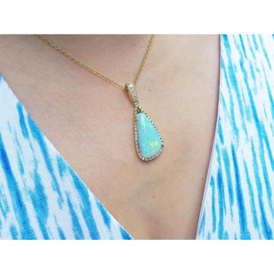 8.05 ct. pear-shaped Australian opal pendant with diamond halo on an 18K yellow gold chain.