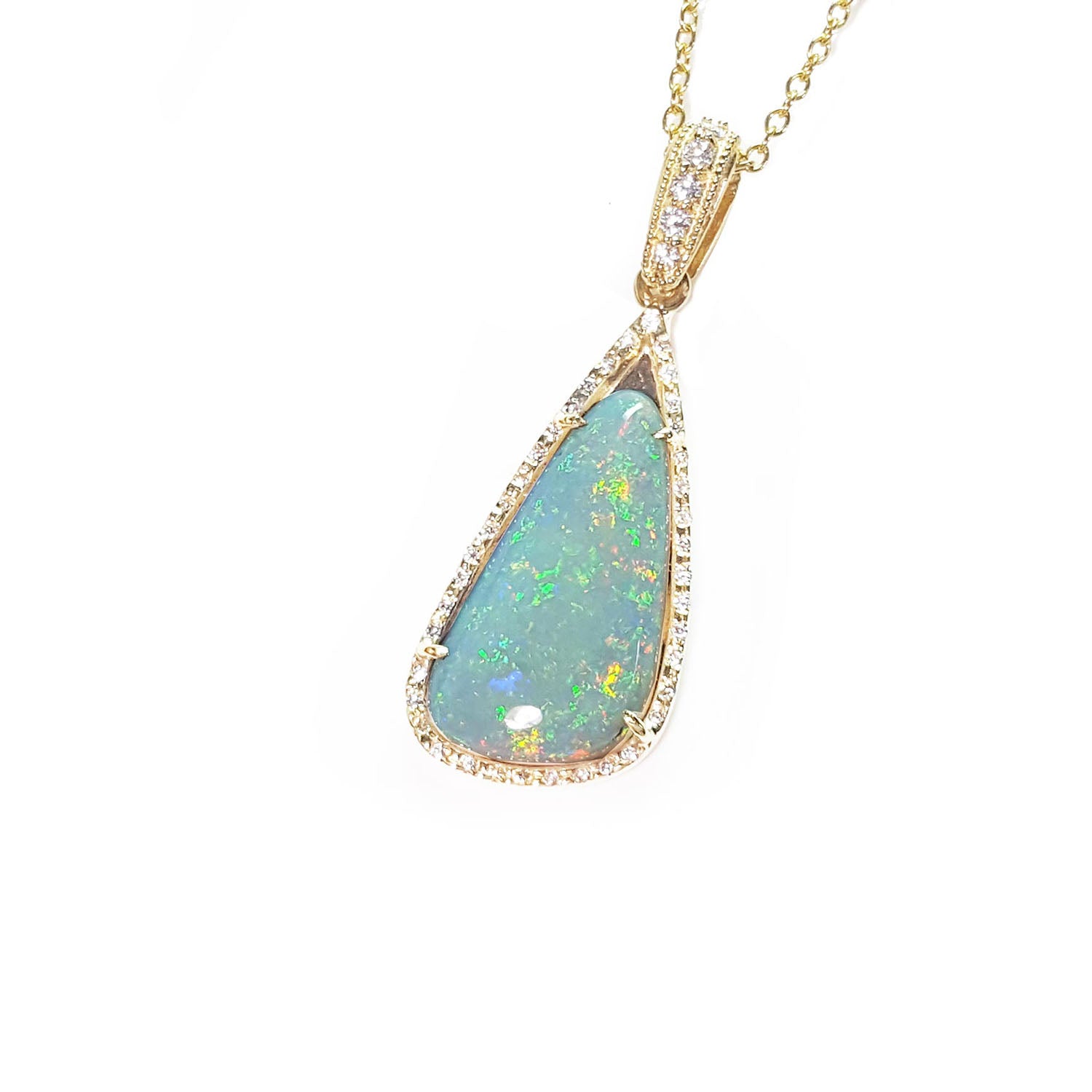 Opal pendant necklace on a gold chain left-side view with a white background