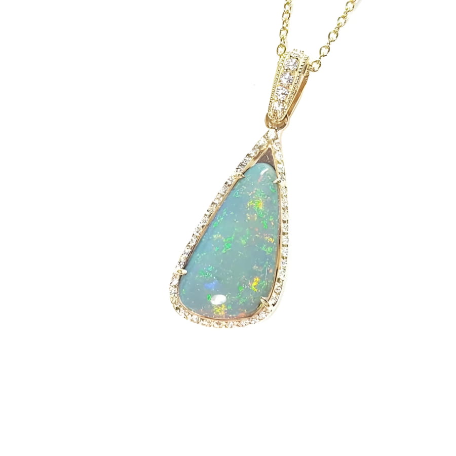 Pear-shaped 8.05 ct Australian opal pendant with bluish-green play of color, halo diamonds, and 18K yellow gold chain.