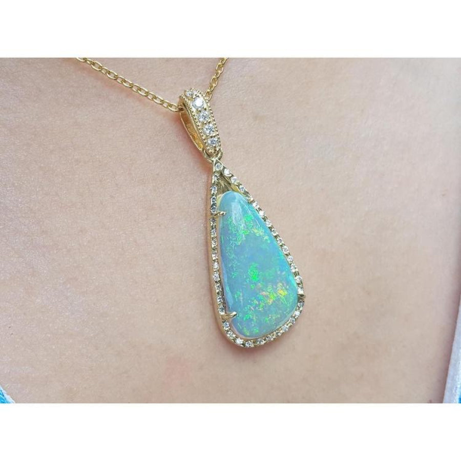 Pear-shaped Australian opal pendant with bluish-green play of colors, halo diamonds, and 18K yellow gold chain.