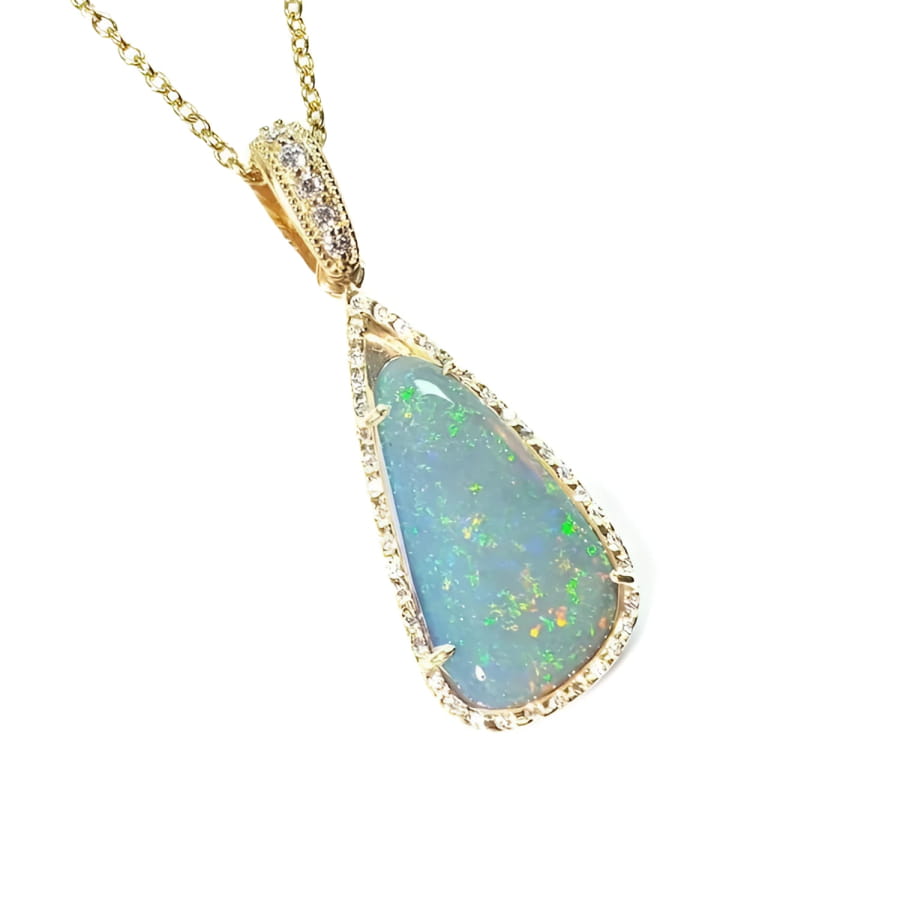 8.05 ct pear-shaped Australian opal pendant with bluish-green play of color, halo diamonds, and 18K yellow gold chain.