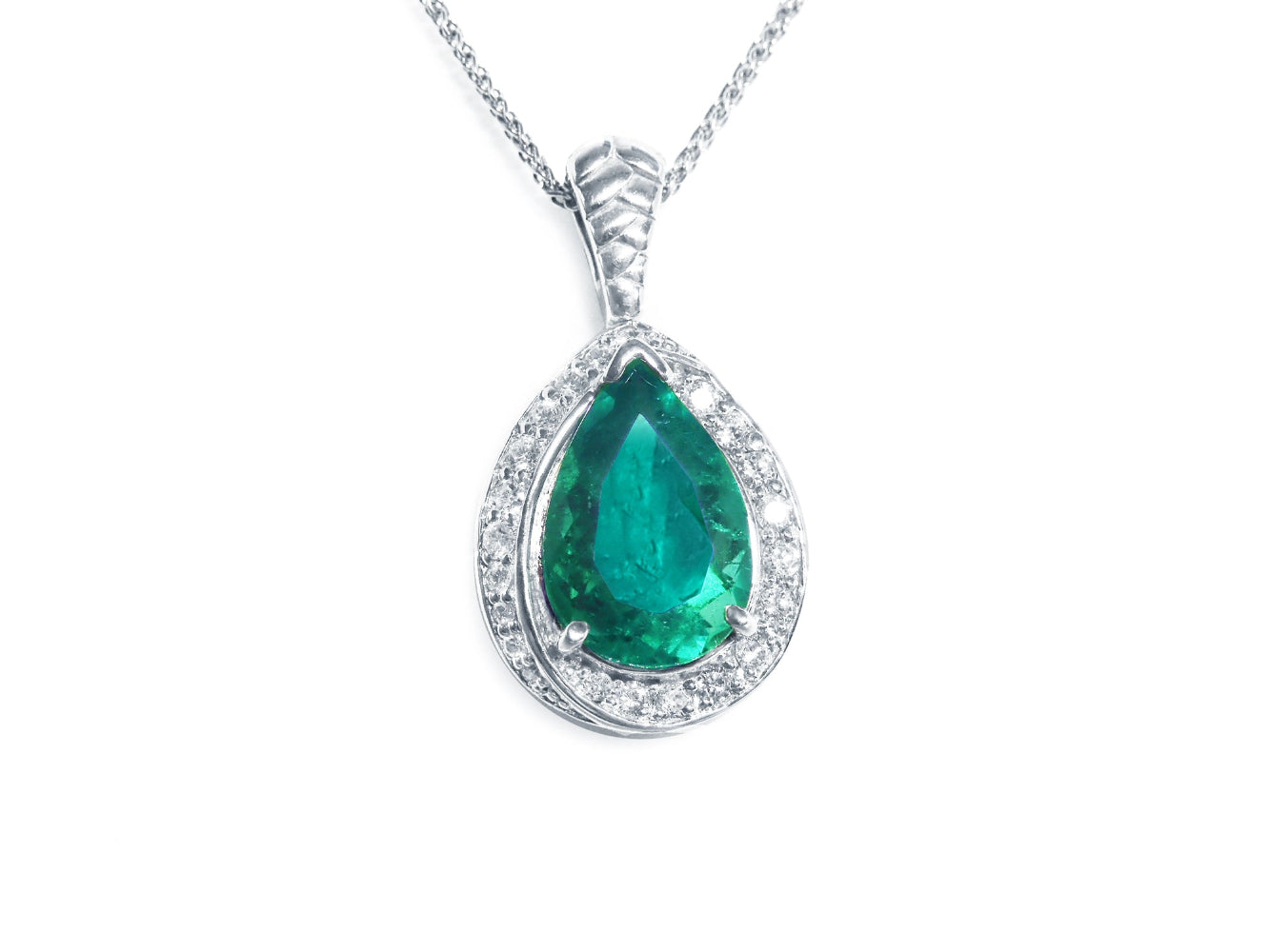 Teardrop-shaped emerald pendant with diamond accents crafted in white gold topside view
