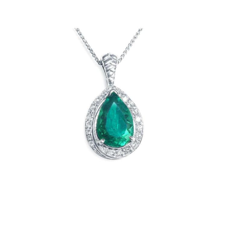 Teardrop-shaped emerald pendant with diamond accents crafted in white gold topside view