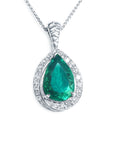 Teardrop-shaped emerald pendant with diamond accents crafted in white gold topside view