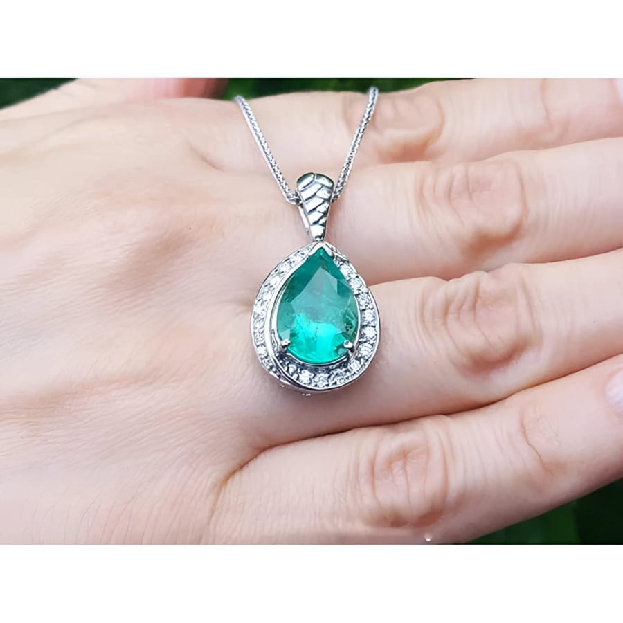 5.03 ct. pear-shaped natural emerald pendant with diamond halo on a 14K white gold chain.