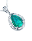 Teardrop-shaped emerald pendant with diamond accents in white gold topside profile