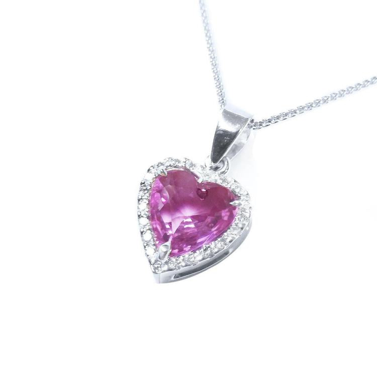 Heart-cut pink sapphire pendant with a diamond halo on an 18K white gold chain.