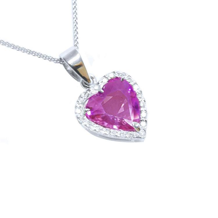 Right position of a natural pink sapphire heart pendant halo diamonds 18k white gold top view