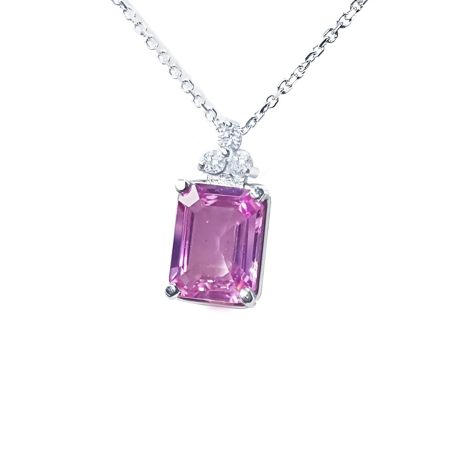 Pink sapphire emerald cut necklace in 14K white gold with diamond accents.