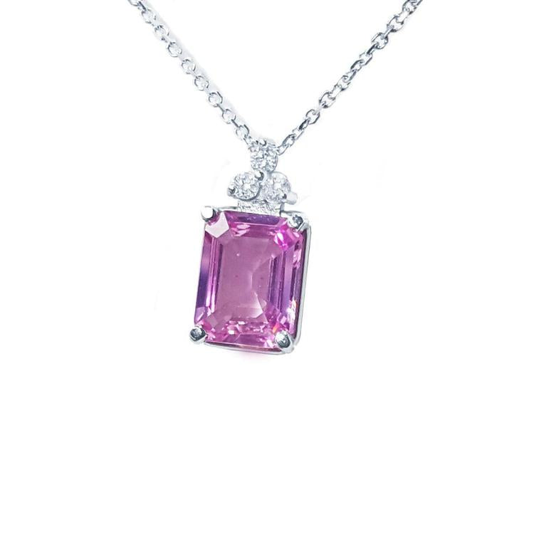 Left side view of a natural pink sapphire necklace emerald cut 2.01 carats 14k white gold.