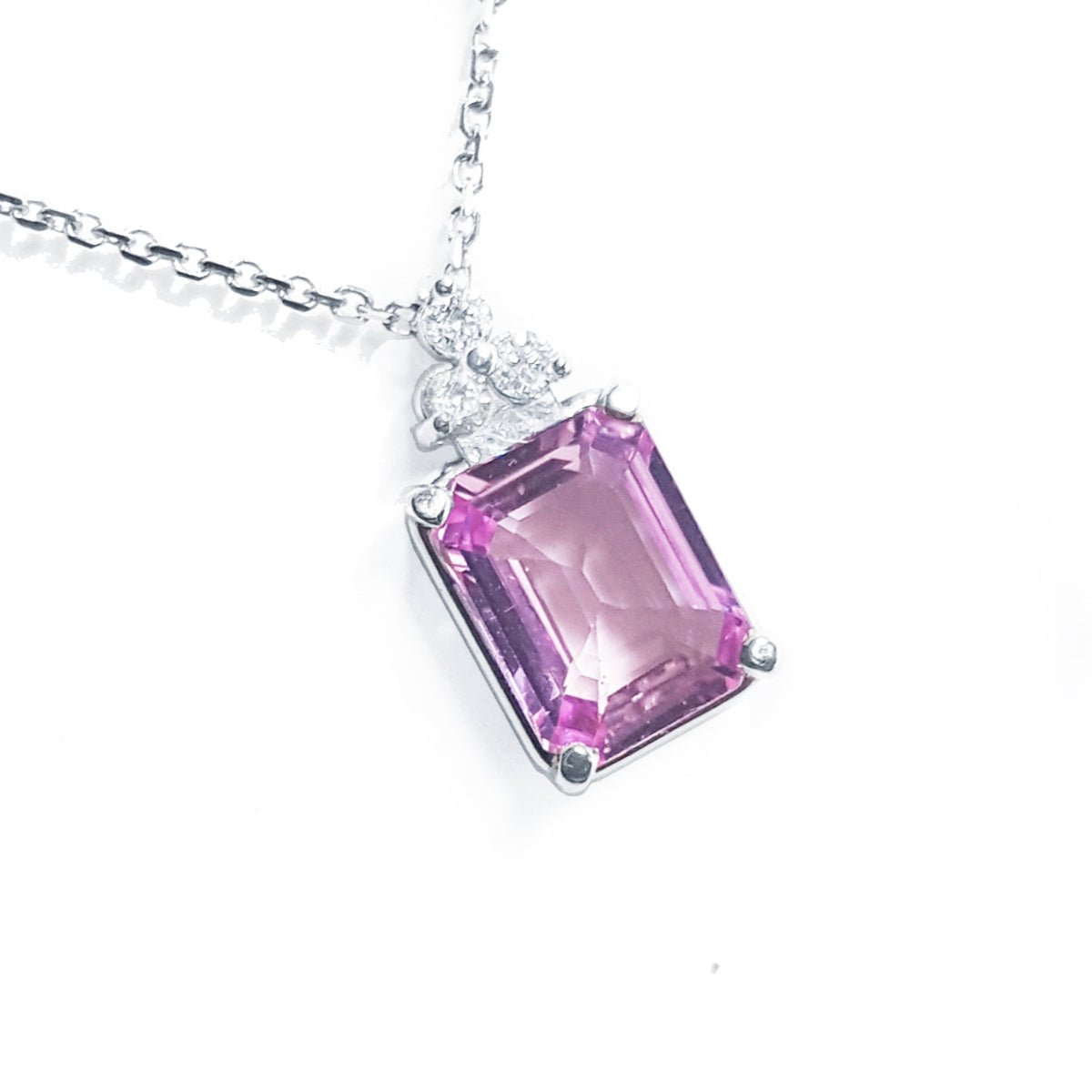 Right side top view of a natural pink sapphire necklace emerald cut 2.01 carats 14k white gold.