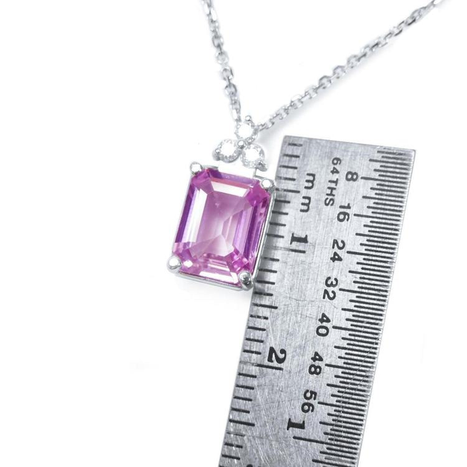 Pink sapphire emerald cut necklace in 14K white gold, shown with a ruler for scale.