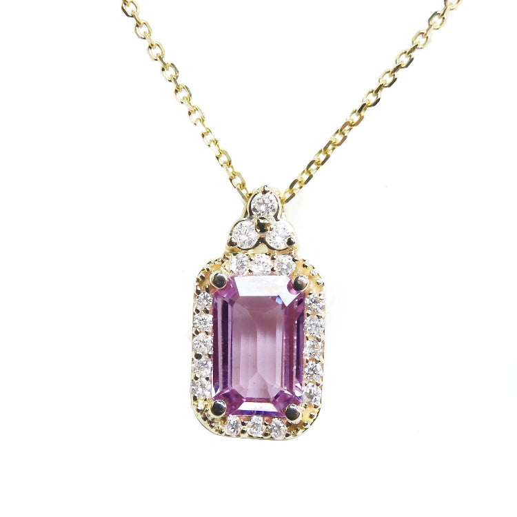 Natural pink sapphire necklace pendant rectangular emerald cut in a medium light hue, surrounded by a halo of natural diamonds and set in 14k gold.