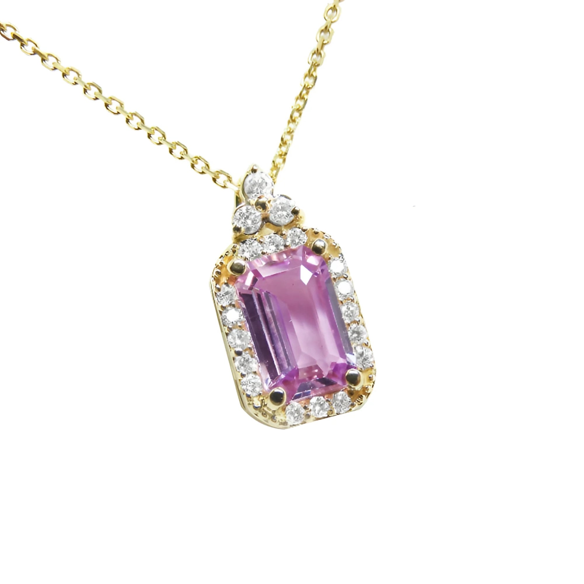 stunning natural pink sapphire necklace pendant featuring a sparkling rectangular emerald cut and set in 14k gold.
