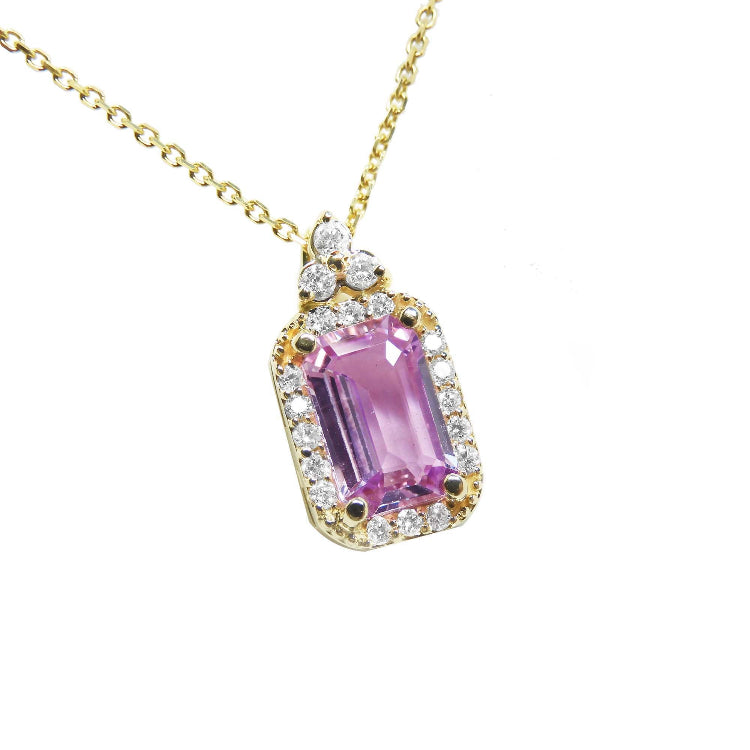 stunning natural pink sapphire necklace pendant featuring a sparkling rectangular emerald cut and set in 14k gold.