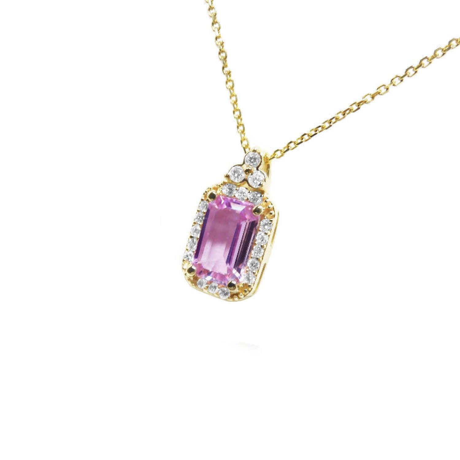 Natural pink sapphire necklace sparkling rectangular emerald cut surrounded by a halo of natural diamonds and set in 14k gold.