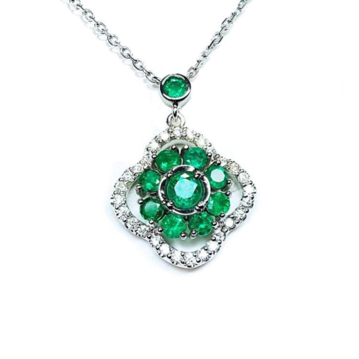 14K white gold cluster necklace with natural Colombian emeralds and diamond clover silhouette.