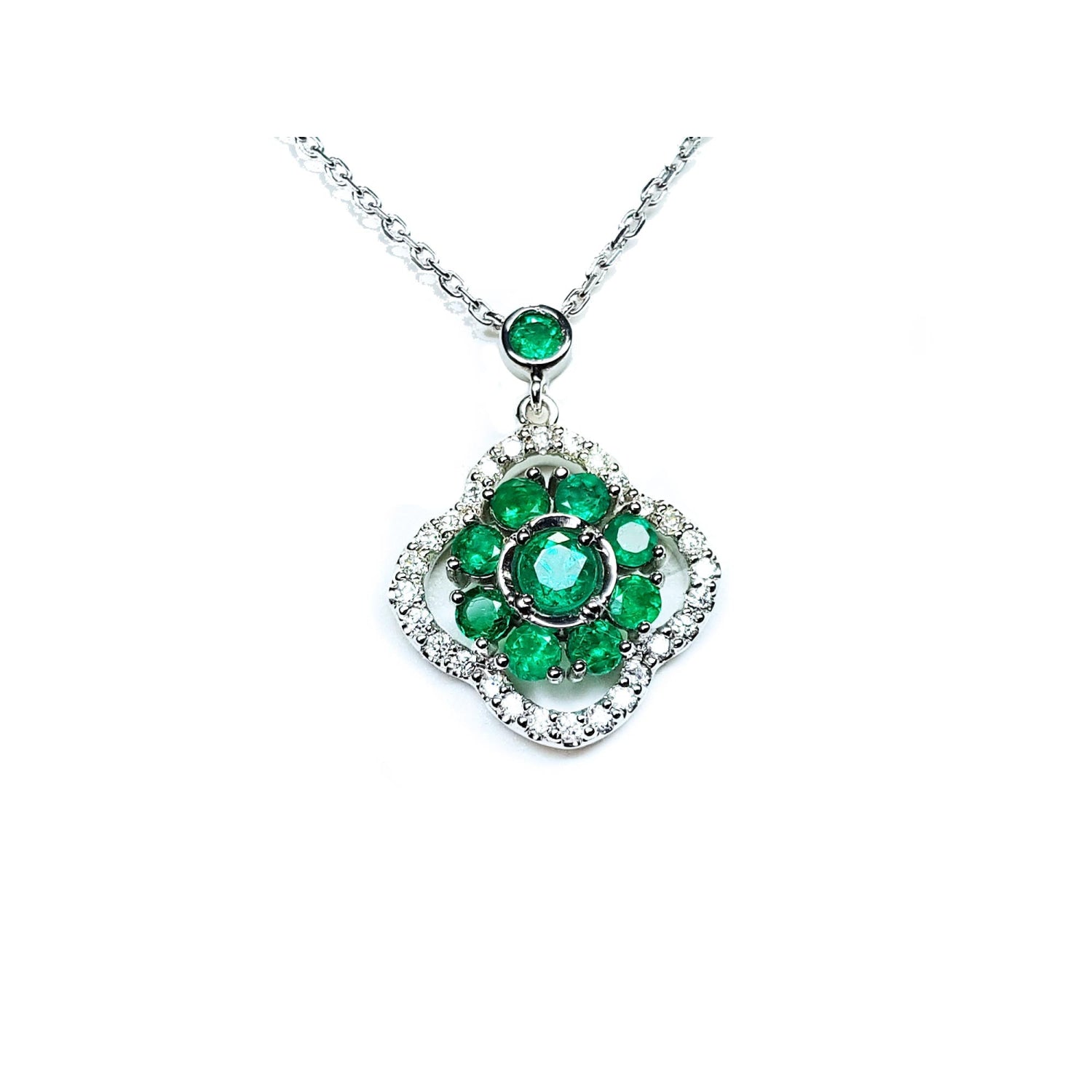 14K white gold cluster necklace with natural Colombian emeralds and diamond clover silhouette.