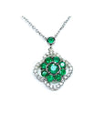 14K white gold cluster necklace with natural Colombian emeralds and diamond clover silhouette.