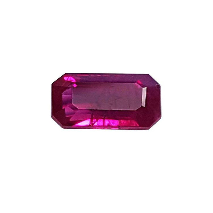 1.11 carat natural emerald-cut ruby gemstone with deep pinkish-red color.