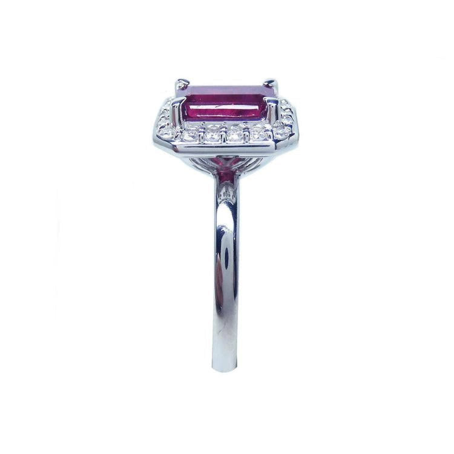 Women's 14K white gold ring with an emerald-cut deep red ruby and diamond halo.