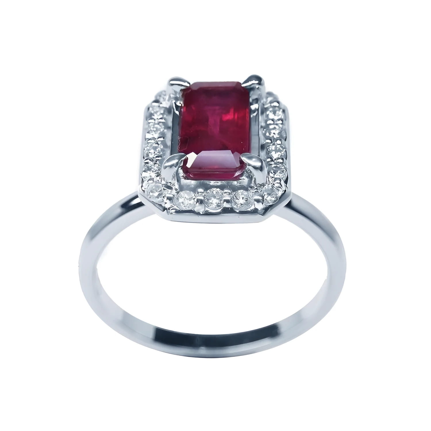 14K white gold ring with an emerald-cut deep red ruby haloed by sparkling diamonds.