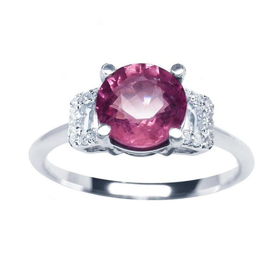 Round cut pinkish-red ruby ring with diamond accents, prong set in 14k white gold.