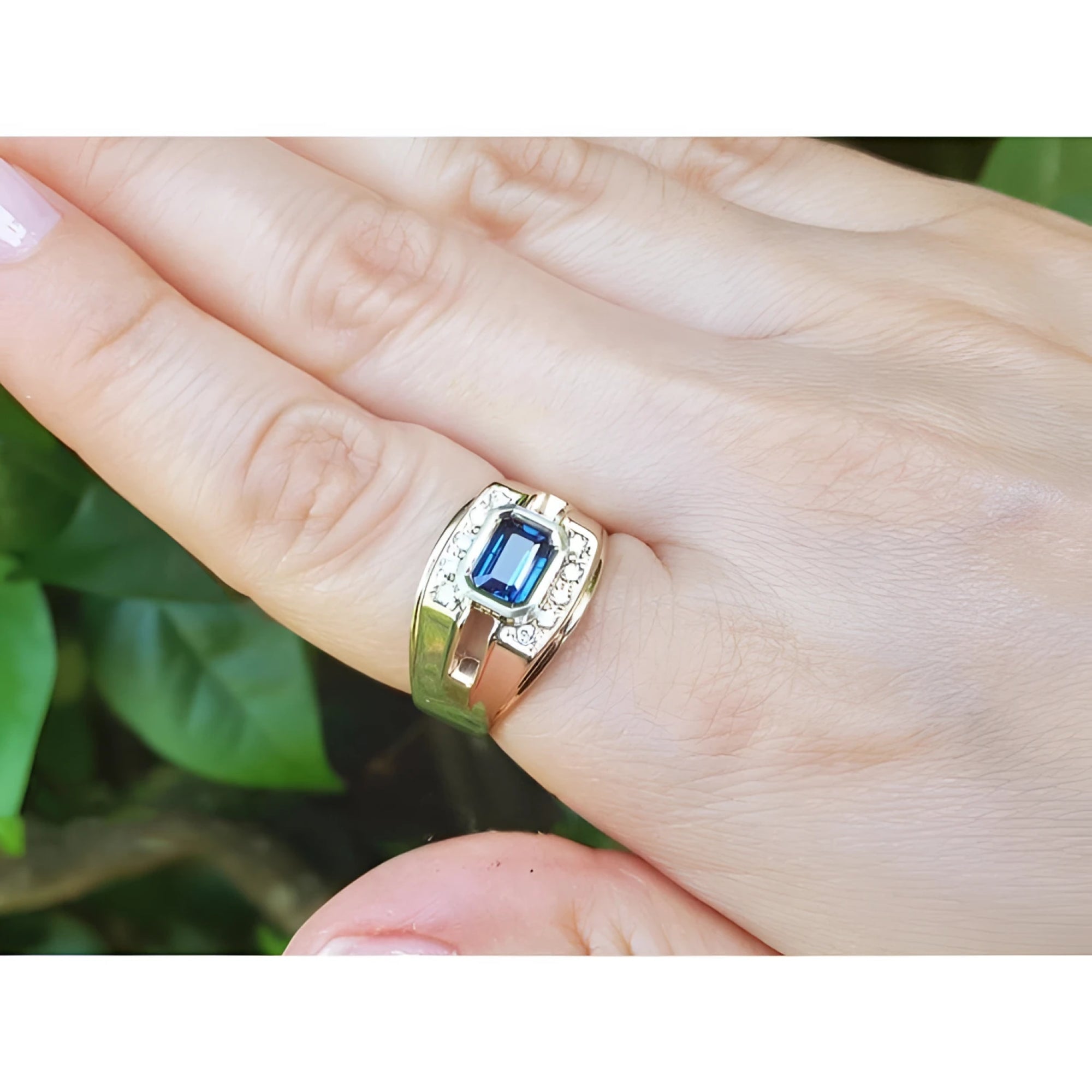 Men's 18K yellow gold ring with east-west bezel-set blue sapphire and diamond accents.