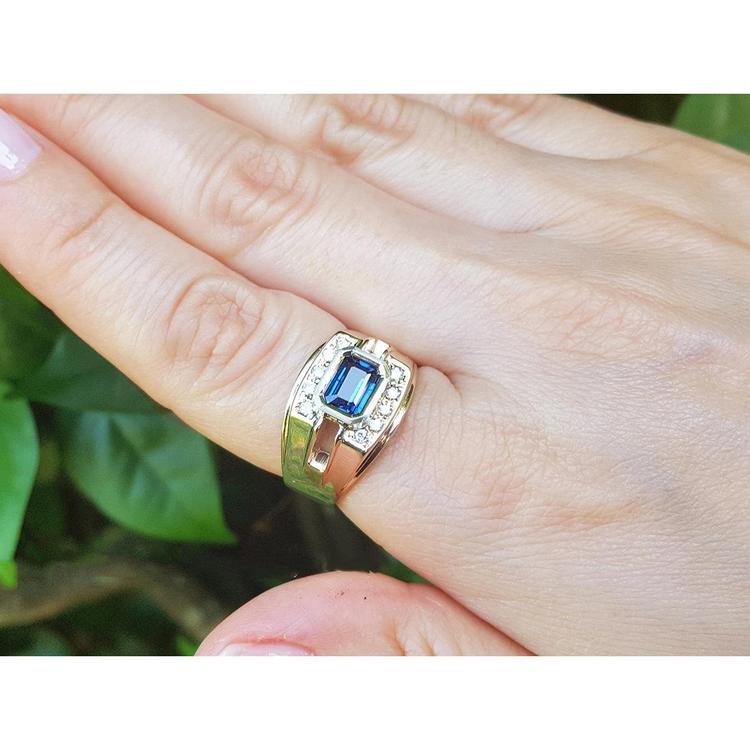 Men's 18K yellow gold ring with east-west bezel-set blue sapphire and diamond accents.
