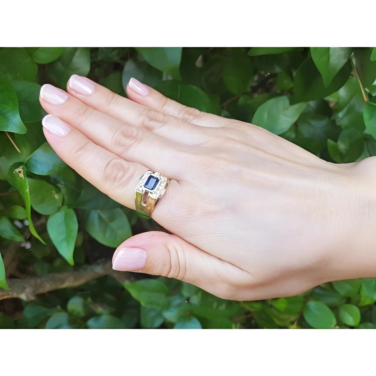 Men's 18K yellow gold ring with an east-west bezel-set blue sapphire and diamond accents.