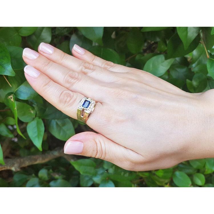 Men's 18K yellow gold ring with an east-west bezel-set blue sapphire and diamond accents.