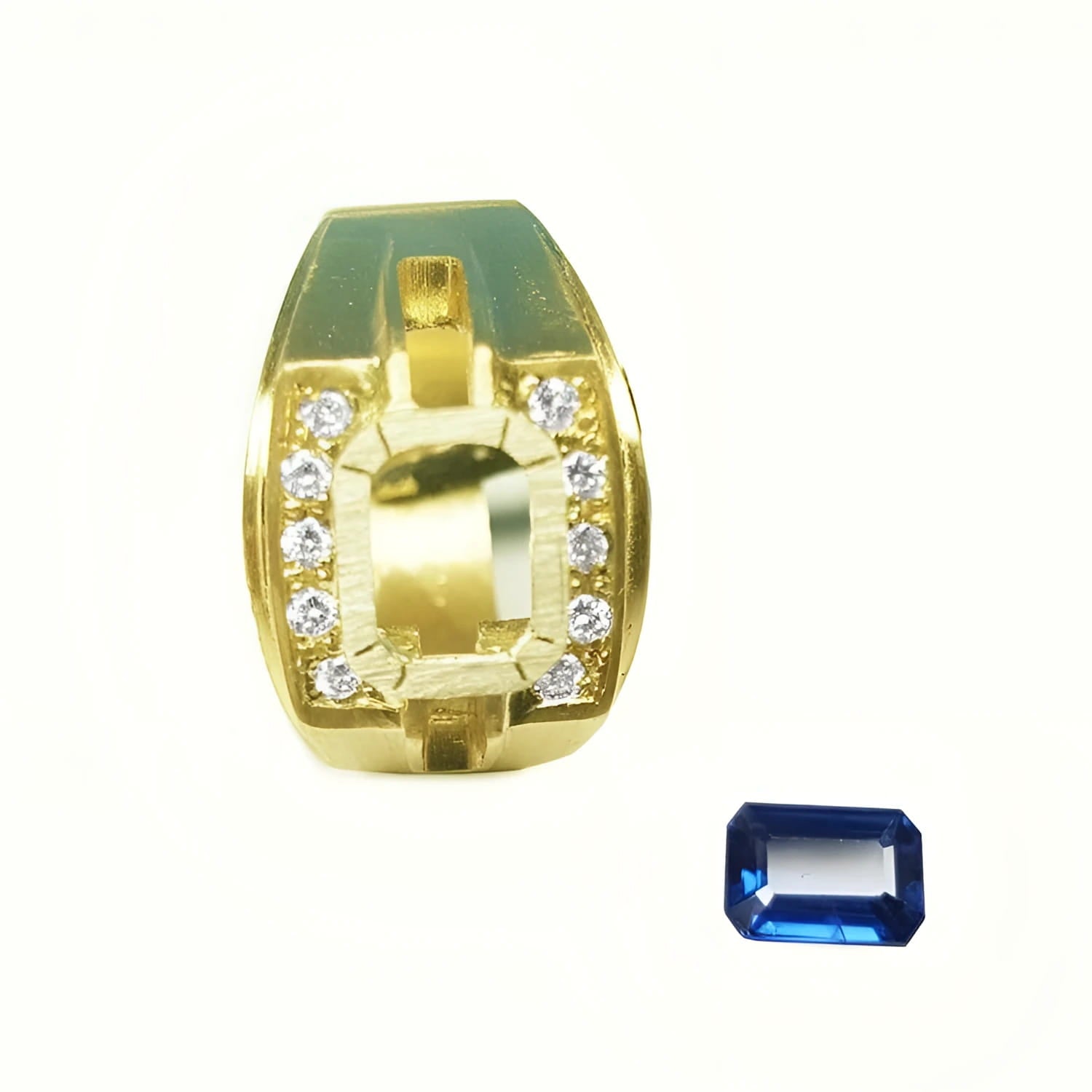18K yellow gold men's ring setting with diamond accents, next to a loose rectangular blue sapphire.