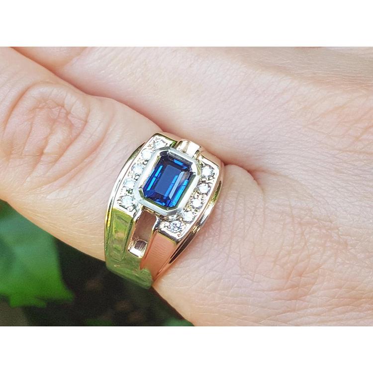 Men's 18K yellow gold ring with east-west bezel-set blue sapphire and diamond accents.