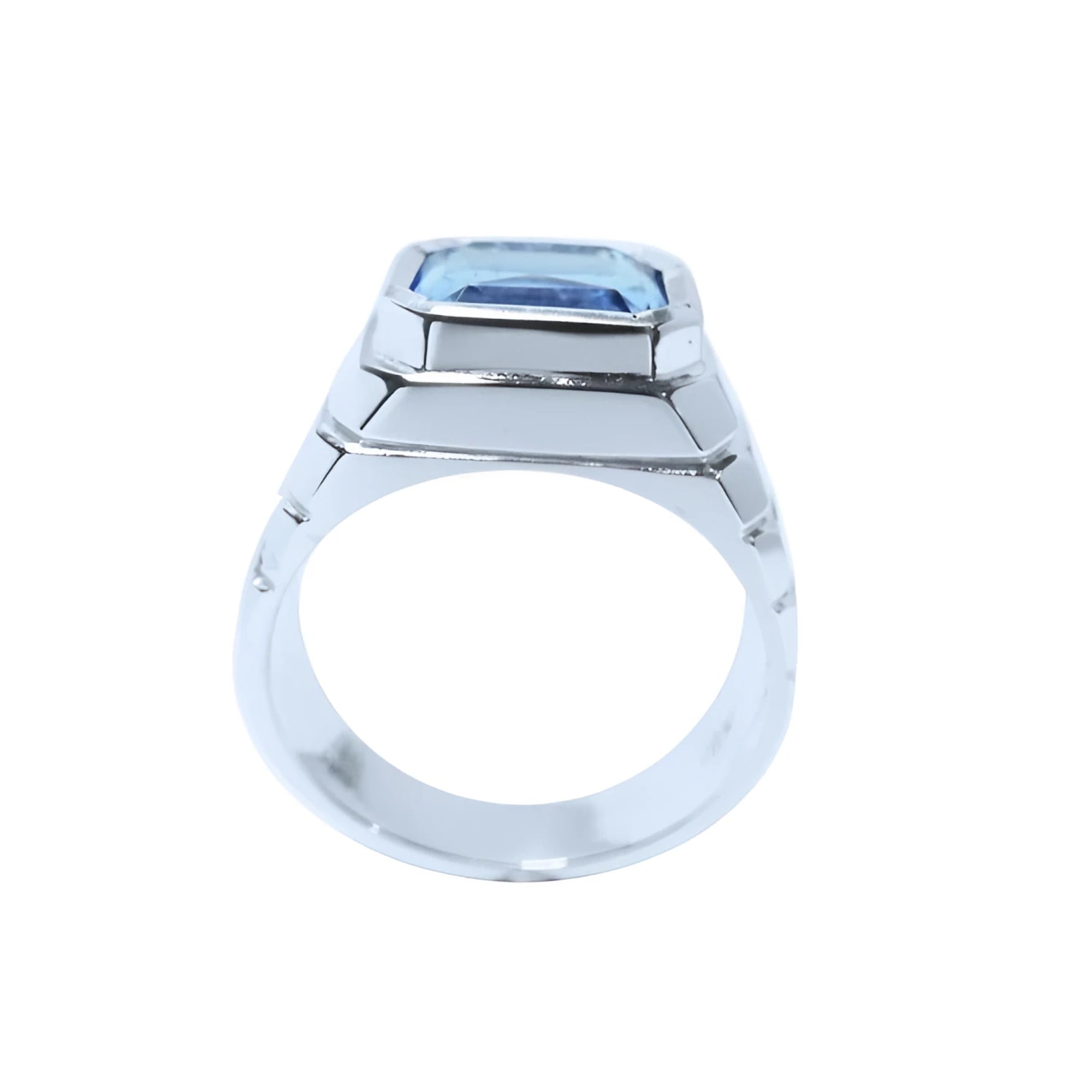Men's 18K white gold ring with a 5.76 ct. emerald-cut blue sapphire in a bezel setting.