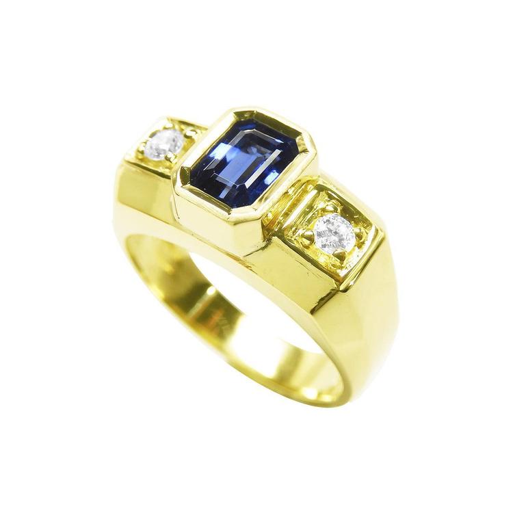 Men's 14K yellow gold ring with a bezel-set emerald cut blue sapphire and two round side diamonds.