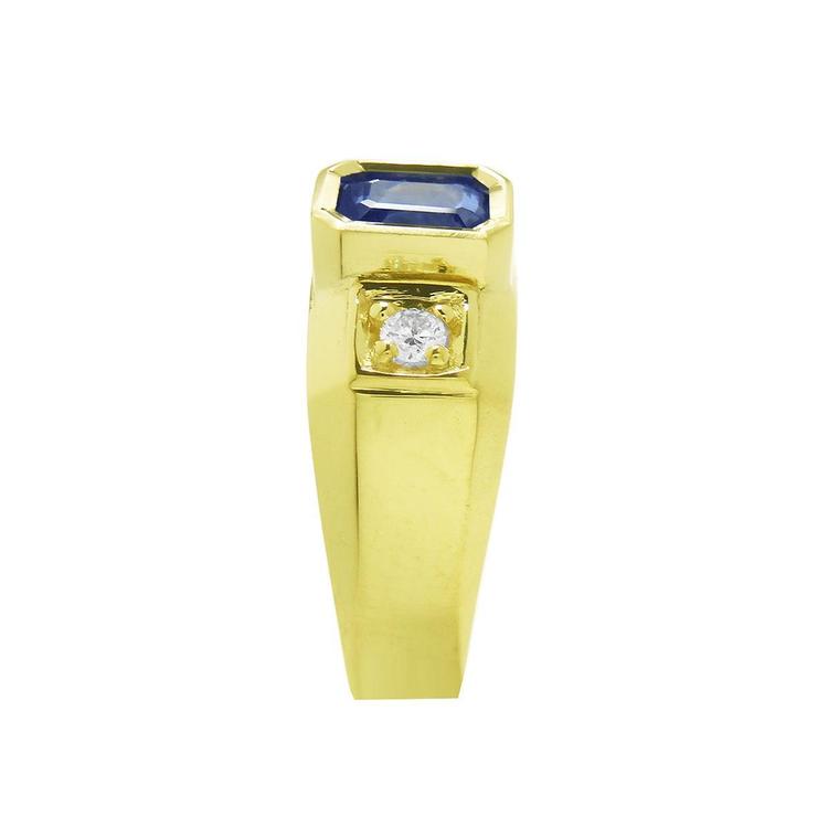 Men's 14K yellow gold ring with an emerald cut blue sapphire and round side diamond.