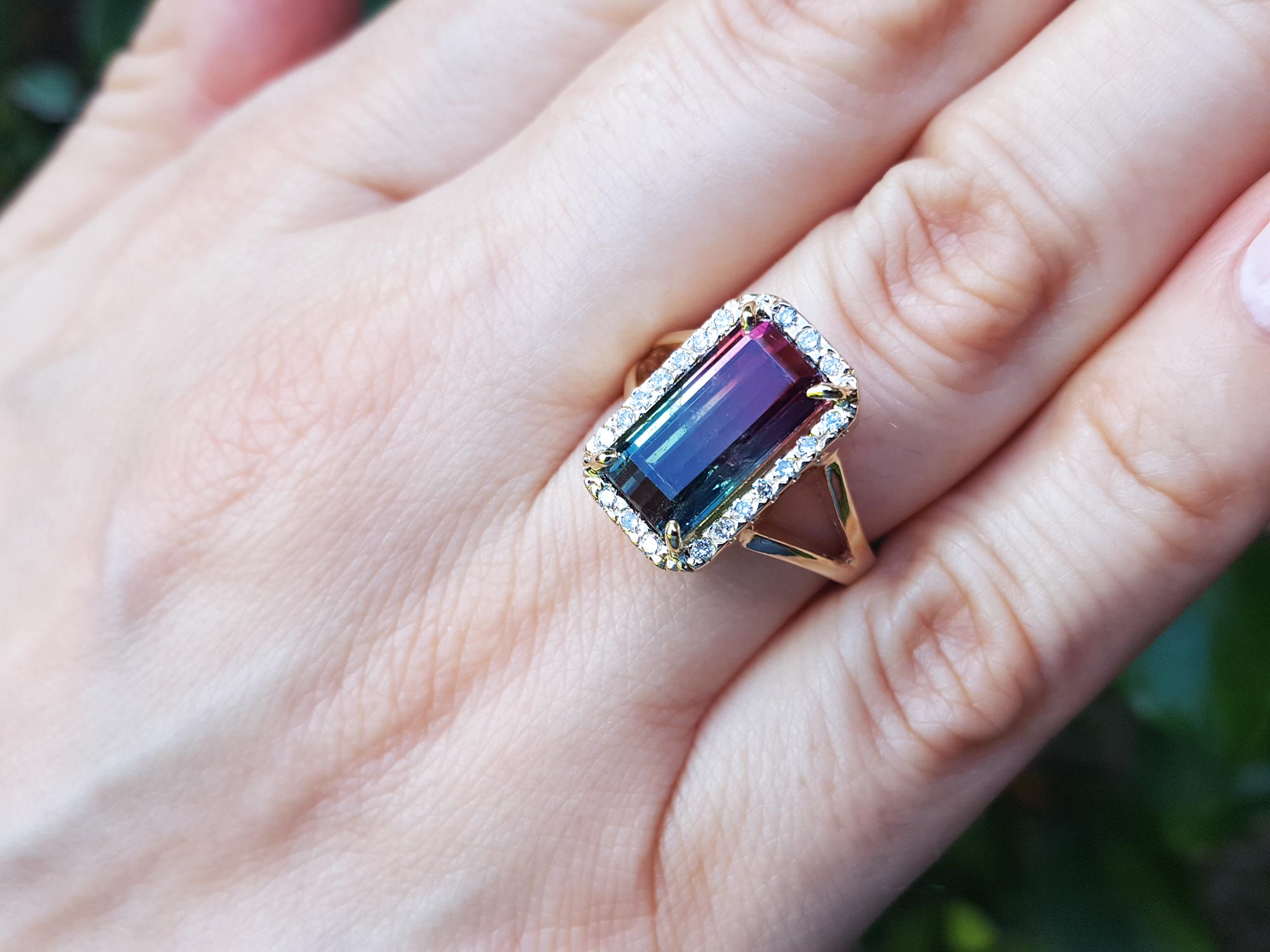 A woman&#39;s hand wearing a watermelon tourmaline ring, close up for details.