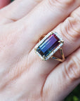 A woman's hand wearing a watermelon tourmaline ring, close up for details.