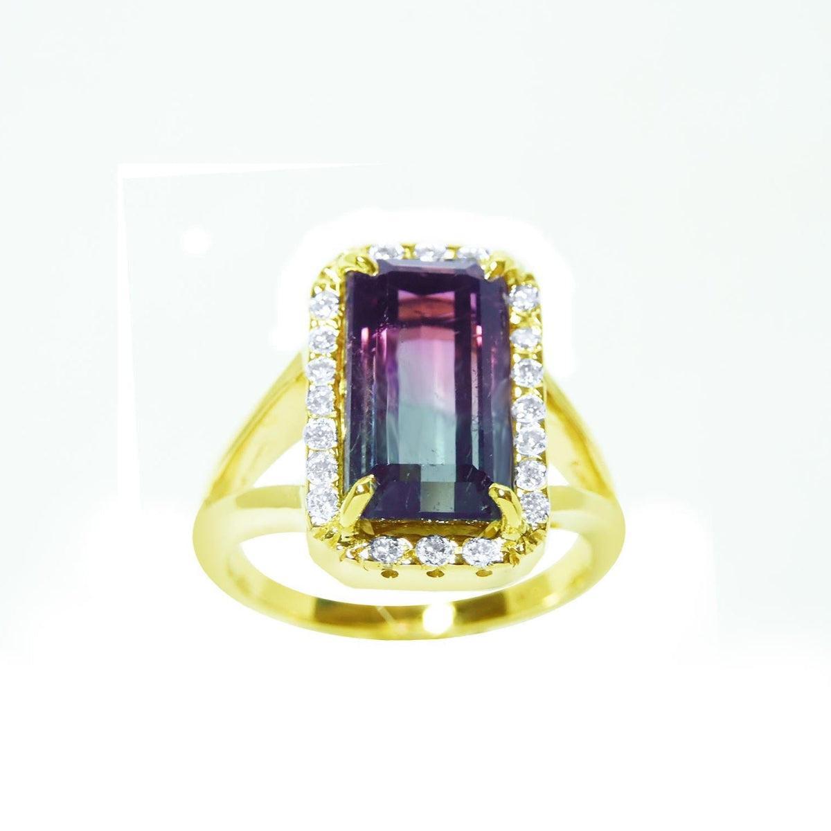 A natural watermelon tourmaline ring with a halo diamond, crafted in 14k yellow gold, from the top-down profile view.