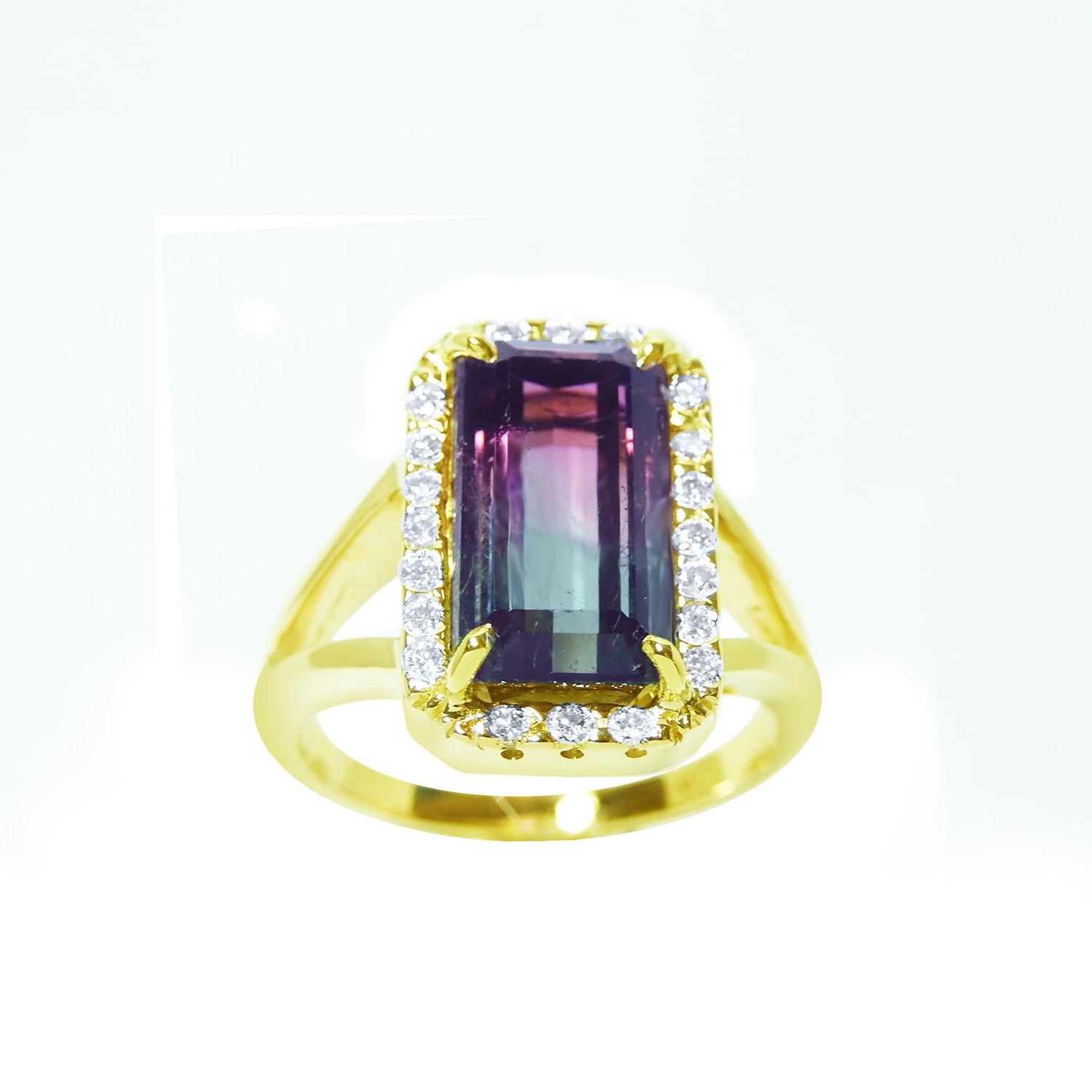 A natural watermelon tourmaline ring with a halo diamond, crafted in 14k yellow gold, from the top-down profile view.