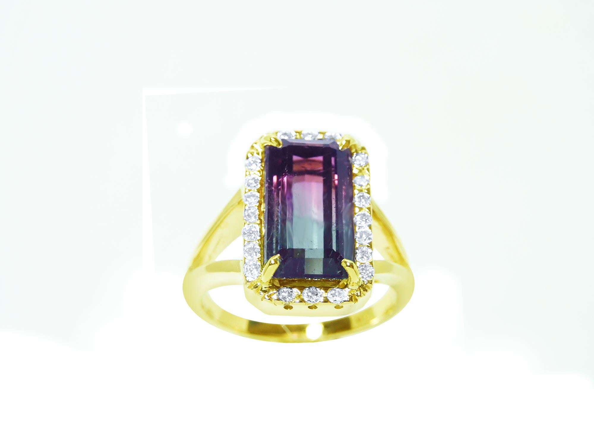 A natural watermelon tourmaline ring with a halo diamond, crafted in 14k yellow gold, from the top-down profile view.