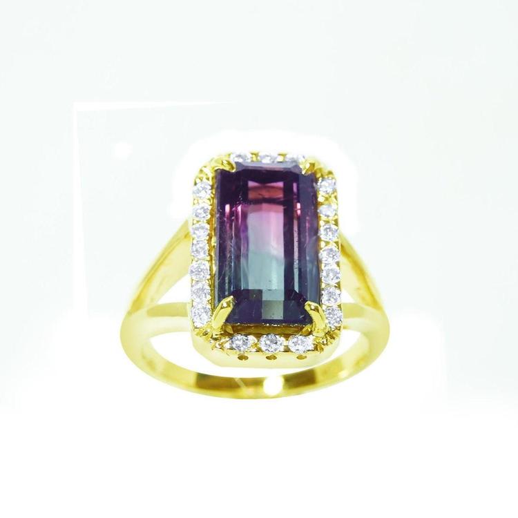 A natural watermelon tourmaline ring with a halo diamond, crafted in 14k yellow gold, split shank.