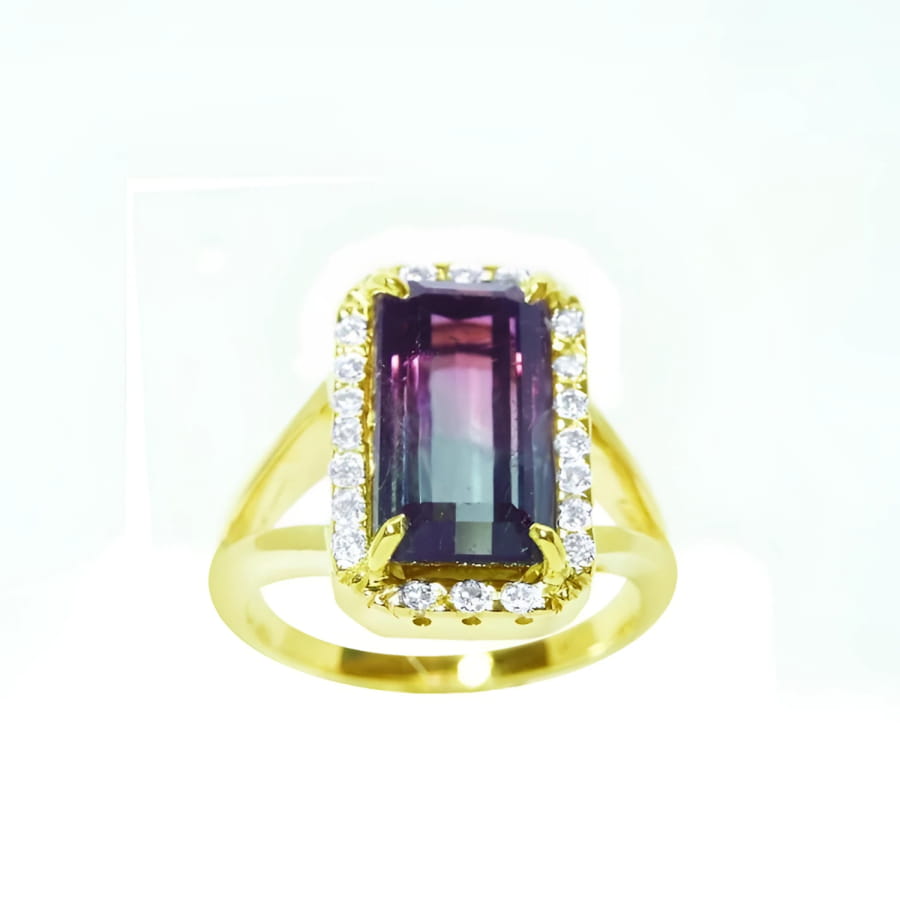 14K gold ring with a rectangular 5.60 ct. green and pink watermelon tourmaline, surrounded by diamonds.